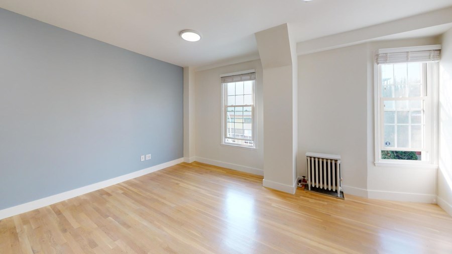 A room with wooden floors and a window.
